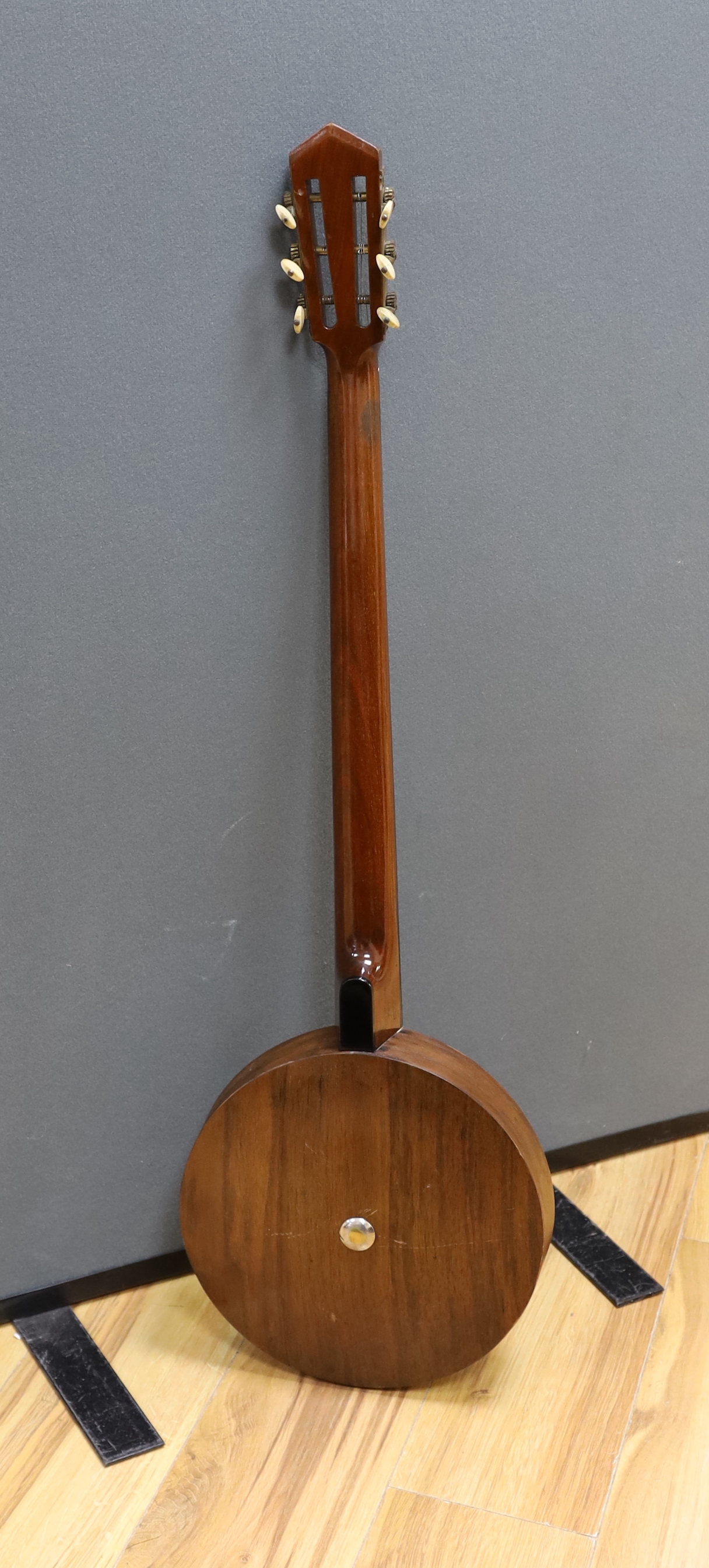 A six string banjo, unmarked, in a hard case by Ashbury